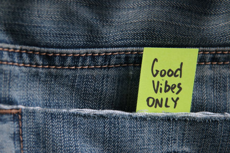 Good vibes only quotation. Motivational quotes inscription on a tag in a pocket of blue jeans.の写真素材