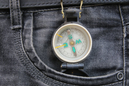 Old vintage compass in jeans pocket. navigation concept.の写真素材