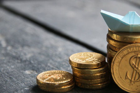 Business success, money, start up concept. Stack of golden coins on table background.の写真素材