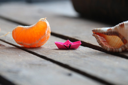 Summertime concept. Slice of tangerine on old vintage table.の写真素材