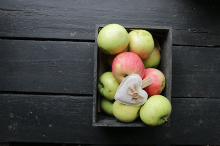 Ripe juicy apples in a box. Seasonal garden harvest apples.の写真素材