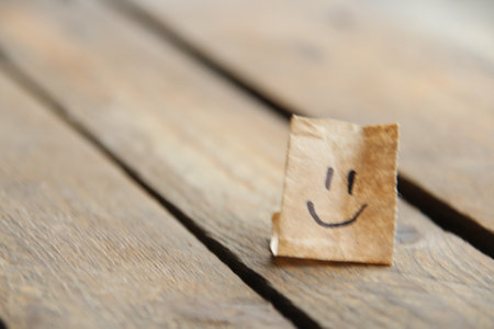 Smiley face on old wooden background, copy space.の写真素材