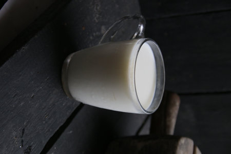 Mug of milk on vintage table. morning breakfast on rustic background. The concept of farm dairy products.の写真素材