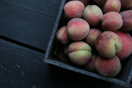 Peaches in a wooden box. top view.の写真素材