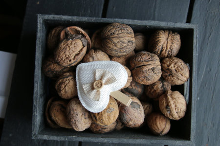 Walnuts and heart in a wooden box. top view.の写真素材