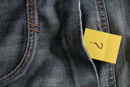A question mark on a paper tag in a jeans pocket. Question mark on jeans.の写真素材