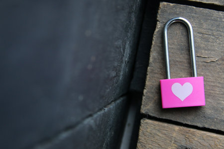 Pink padlock with a heart. Birthday background. Creative Romantic background.の写真素材