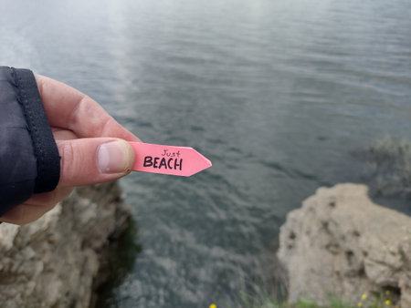 Beach idea. A hand holds a pointer with the inscription beach.の写真素材