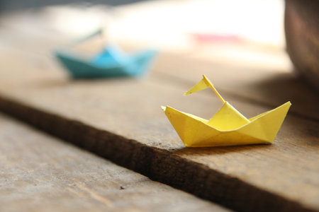 Summer travel concept. Paper boats on vintage wooden background.の写真素材