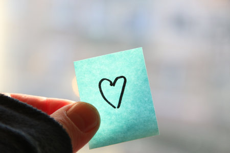 Heart on a blue paper tag. Happy Birthday background.の写真素材