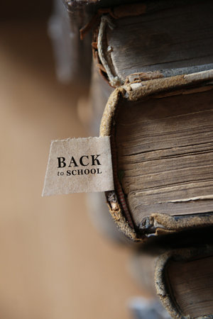 Back to school tag and Book on old wooden table.の写真素材