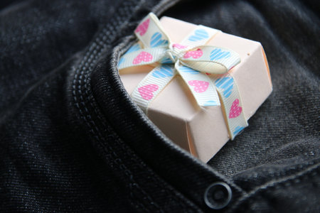 Gift box in pocket of jeans.の写真素材