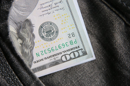 American dollars USD banknotes in jeans pocket.