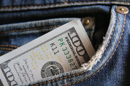 Dollar money in the pocket of jeans. Banknote One hundred dollar.の写真素材