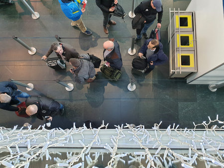 Saint-Louis, Haut-Rhin / France - December 14, 2019: People stand in line in front of the passport...