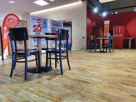 Gossau, Sankt Gallen - Switzerland - May 20, 2020: Tables arranged far apart in the Coop restaurant to ensure that guests are kept apart. Empty restaurant not visited for fear. The new normal.のeditorial素材