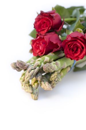 Still life of asparagus and red rosesの写真素材
