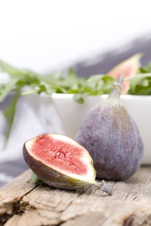Figs on a wood plate with rocket saladの写真素材