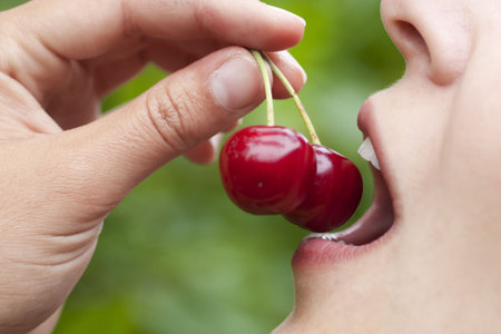 Young woman eathing cherries