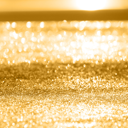Festive abstract background with shiny gold sparkle effectの写真素材