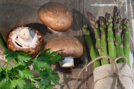 Asparagus and mushrooms on rustic wooden backgroundの写真素材