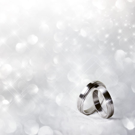 Wedding rings in front of festive backgroundの写真素材