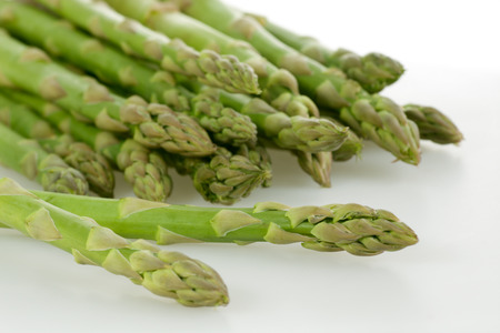 Freshly harvested green asparagus on white backgroundの写真素材
