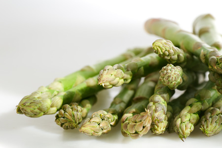 Freshly harvested green asparagus on white backgroundの写真素材