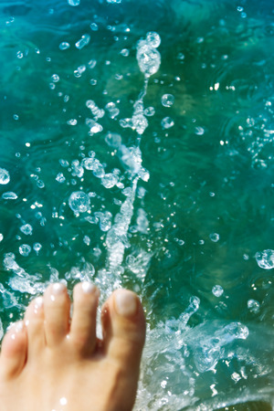 Woman walking and splashing at the North sea beachの写真素材
