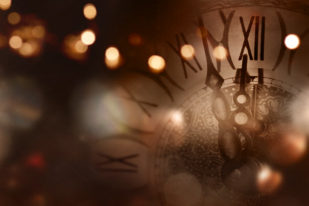 New year background with a clock in front of a tableの写真素材