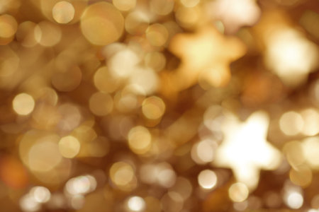 Wonderful golden background with stars and bokeh for christmasの写真素材