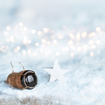 Winter motif for Christmas with a star and a champagne cork in the snowの写真素材