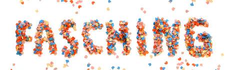 Carnival background with colorful confetti letters on white backgroundの写真素材