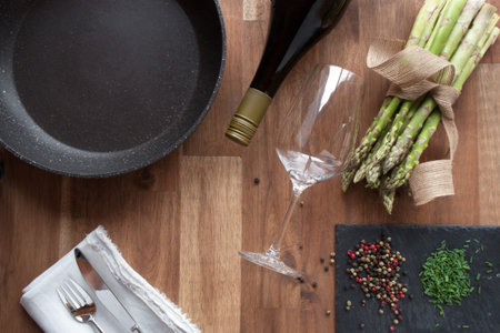 Close up preparing for a eating with fried asparagus on a wooden table