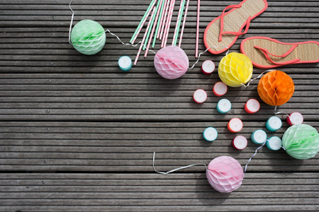 Colorful accessories for a summer festival on a wooden terrace