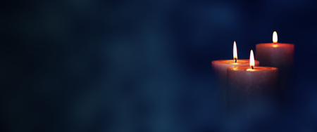 Candle lights in blue darkness for contemplative momentsの写真素材