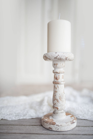 Still life with white candle in vintage style on a wooden altarの写真素材