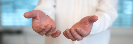 Doctor with outstretched open hands to take somethingの写真素材