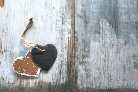 Two hearts in vintage style on old shabby wood for mothers day top viewの写真素材