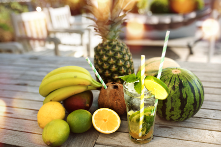 Exotic summer drink and fresh fruits on a sunny terrace with bokehの写真素材