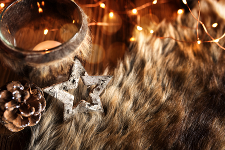Christmas decoration in country house style with a cuddly fleece on a wooden tableの写真素材