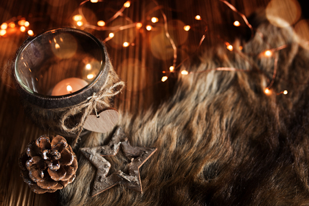 Cozy christmas decoration on rustic wooden table with a light stringの写真素材