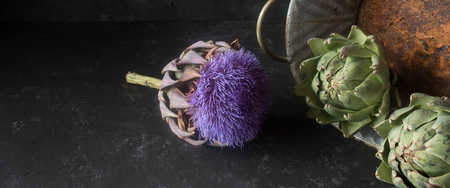 Fresh artichokes decorated on a slate plateの写真素材