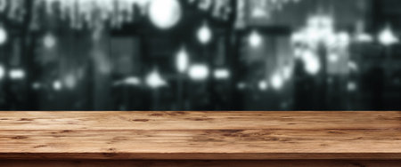 Dark city scenery at a bar with bright lights in front of an empty wooden table