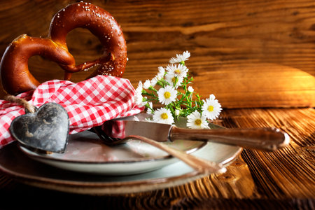 Traditional Bavarian place setting on rustic wood for an oktoberfest