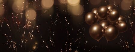 Celebratory bokeh background with laburnum and golden balloonsの写真素材
