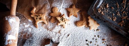 Traditional homemade christmas cookies on old wooden table top viewの写真素材