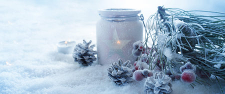 Frosty blue winter still life with a burning christmas light  decorated in snow for a greeting cardの写真素材