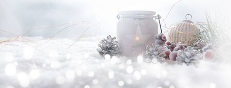 Frosty winter christmas still life decorated in snow with bright sparkling bokehの写真素材