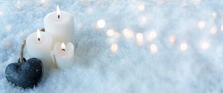 Winter still life in snow with blue atmosphere and bright bokehの写真素材